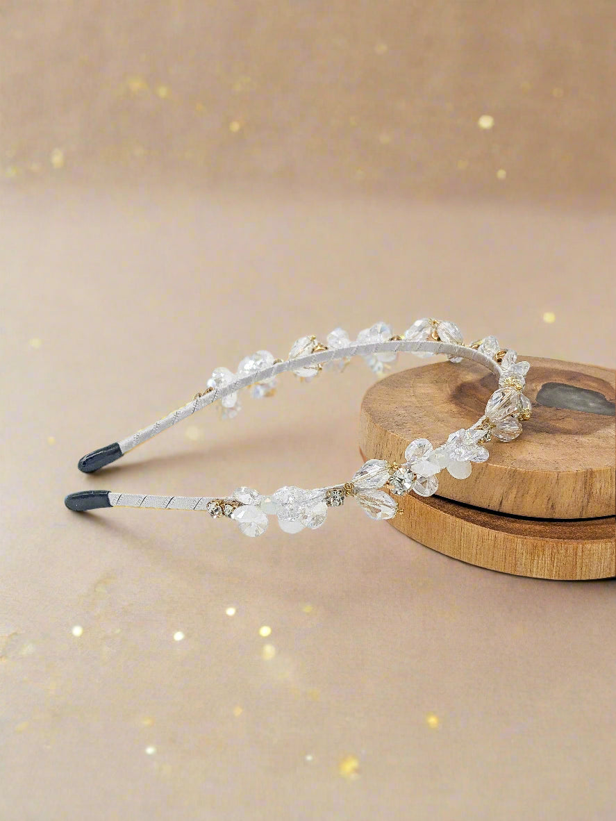 Beaded headband on a wooden block with a white background