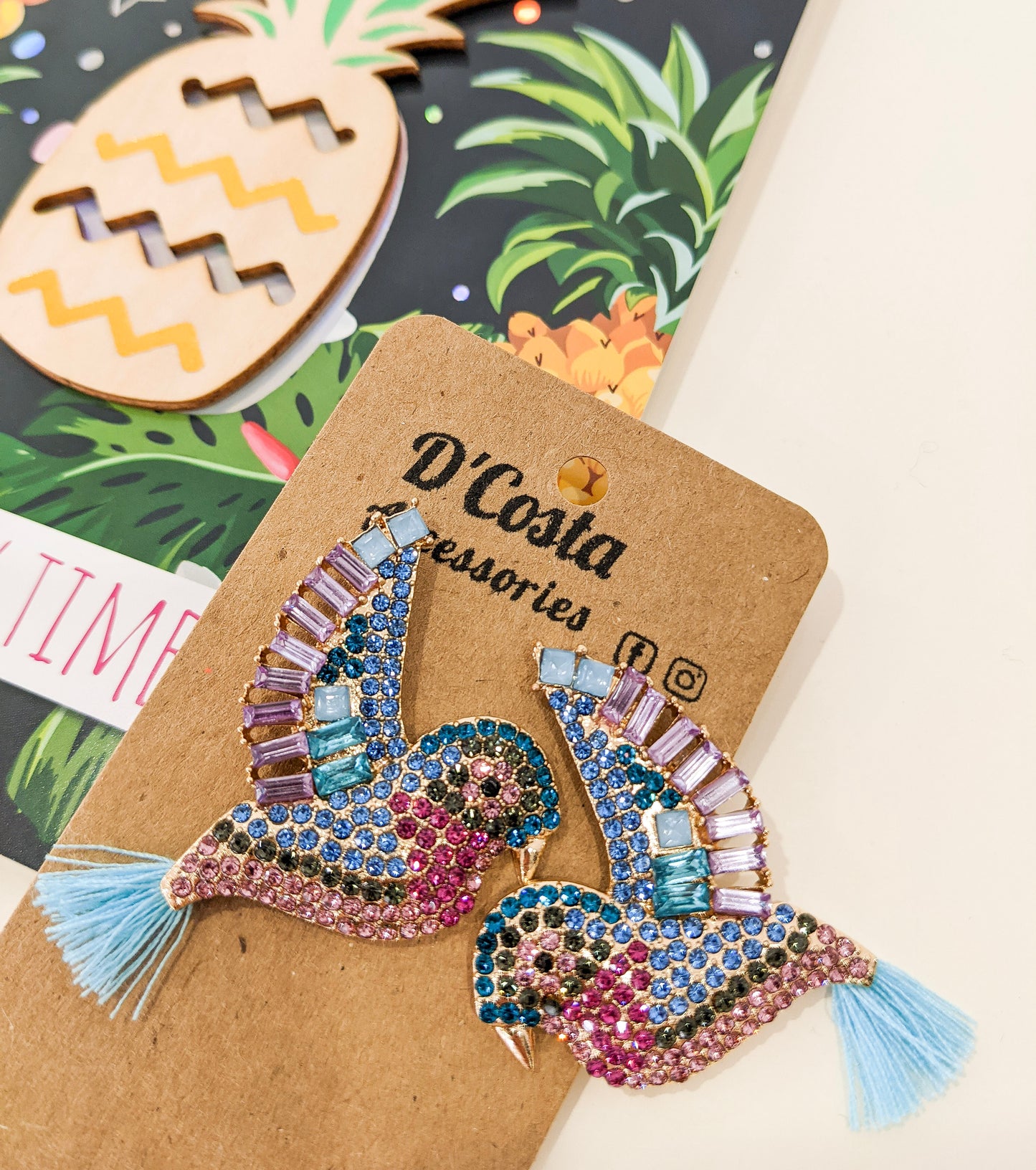 Large, statement rhinestone bird earrings encrusted with colourful diamantes.