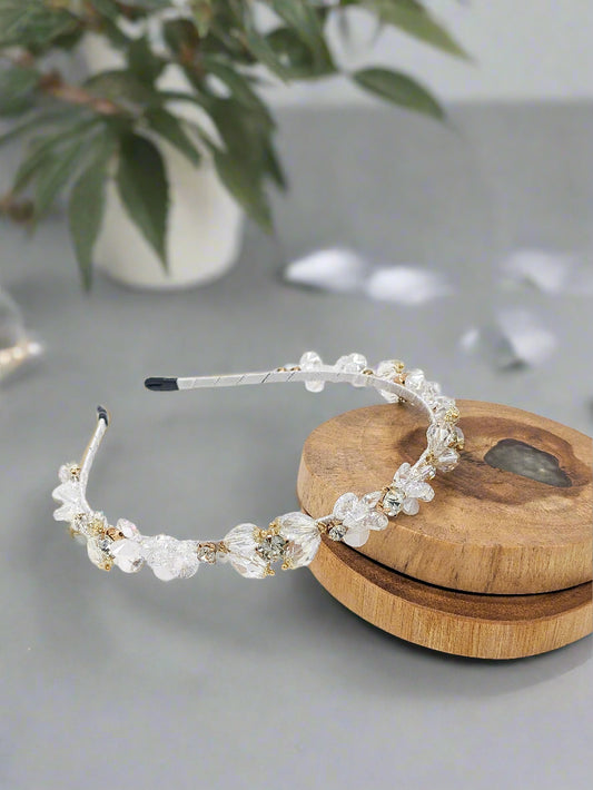 Beaded headband on a wooden block with a white background