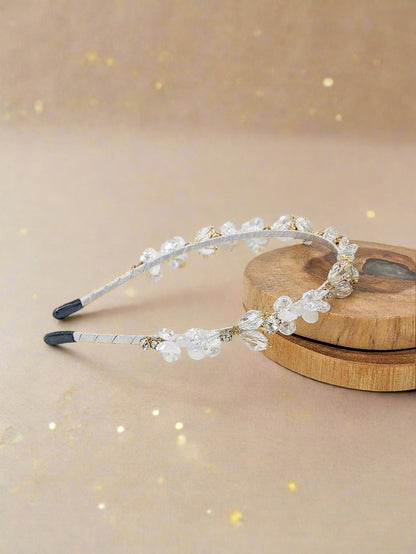 Beaded headband on a wooden block with a white background