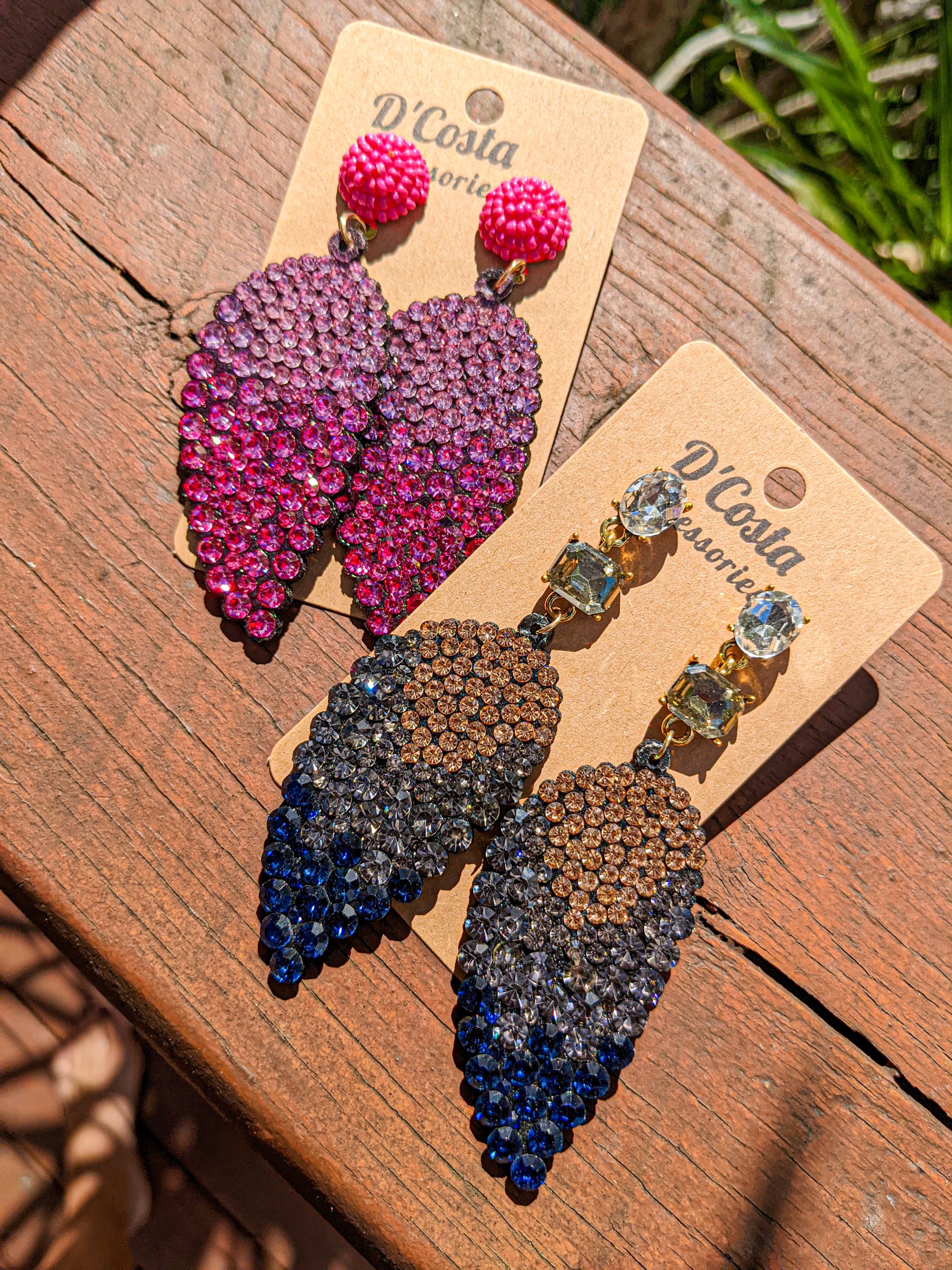 Leaf shaped statement drop earrings encrusted in pink diamante rhinestones.