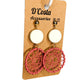 Large statement pink woven circle drop earrings with white circles above.