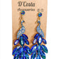 Large royal blue statement peacock earrings, encrusted with royal blue diamante tails and set in a gold tone peacock body.