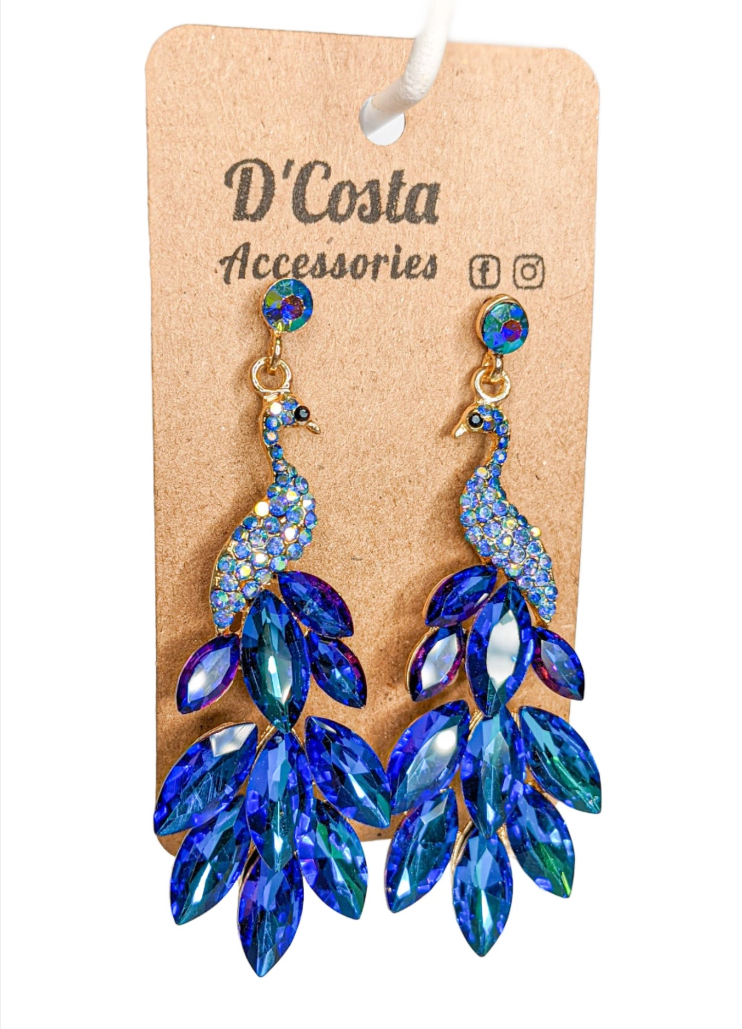 Large royal blue statement peacock earrings, encrusted with royal blue diamante tails and set in a gold tone peacock body.