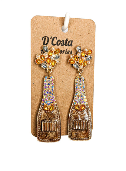 Brown, yellow and gold coloured rhinestone diamante champagne bottle statement earrings. Encrusted with pearlescent diamantes