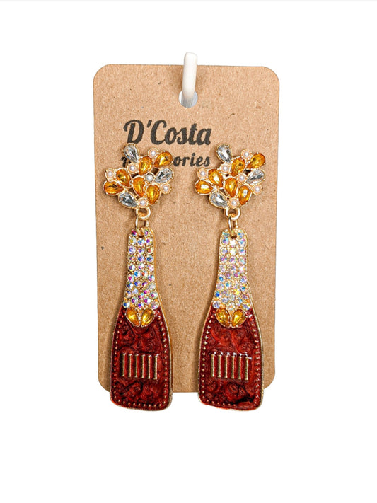 Red, yellow and gold coloured rhinestone diamante champagne bottle statement earrings. Encrusted with pearlescent diamantes