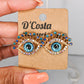 Evil eye statement stud earrings with blue and white pearlescent diamantes