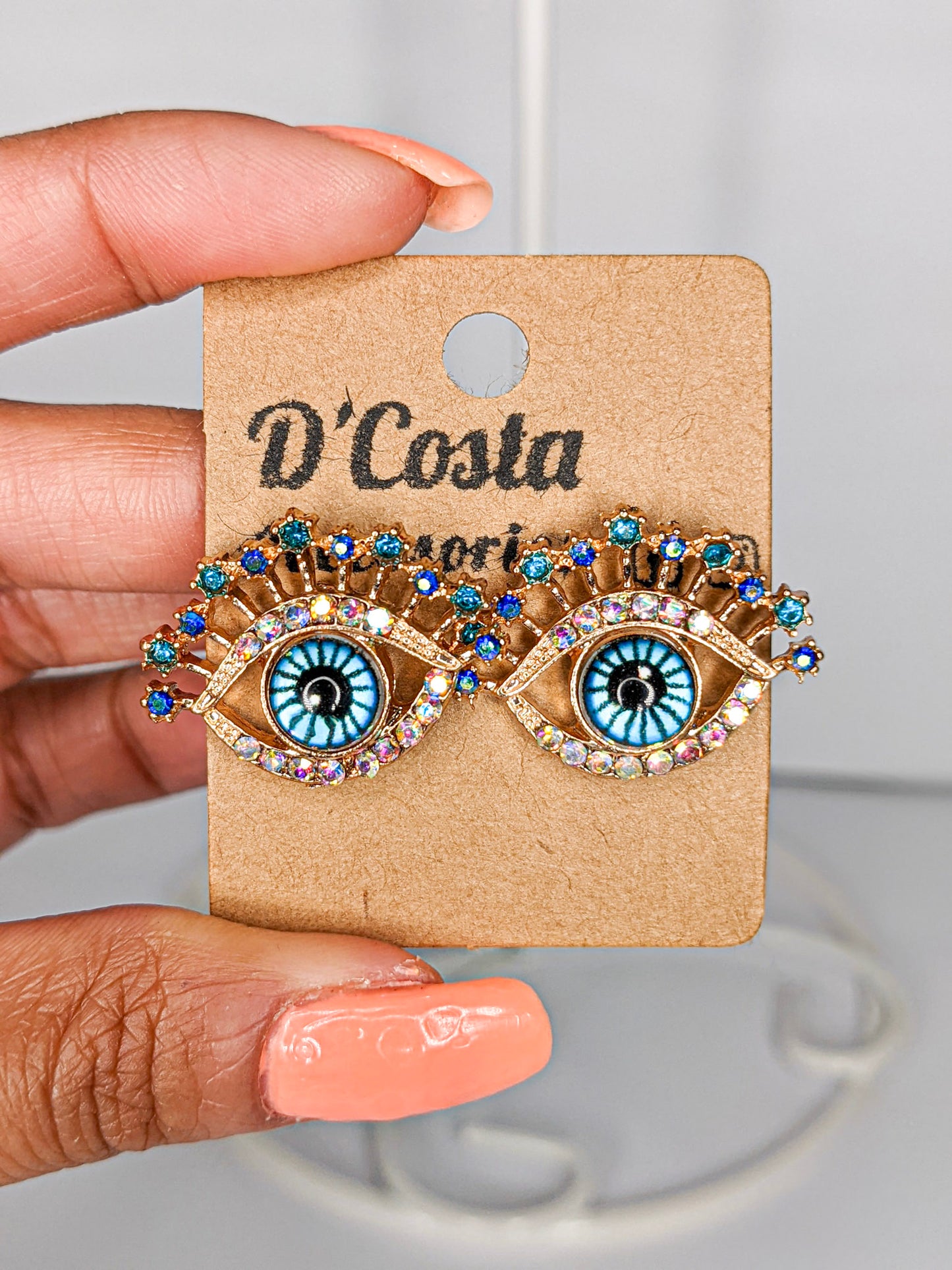 Evil eye statement stud earrings with blue and white pearlescent diamantes